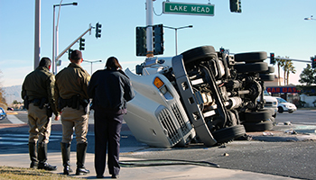 An overturned truck rests on its side